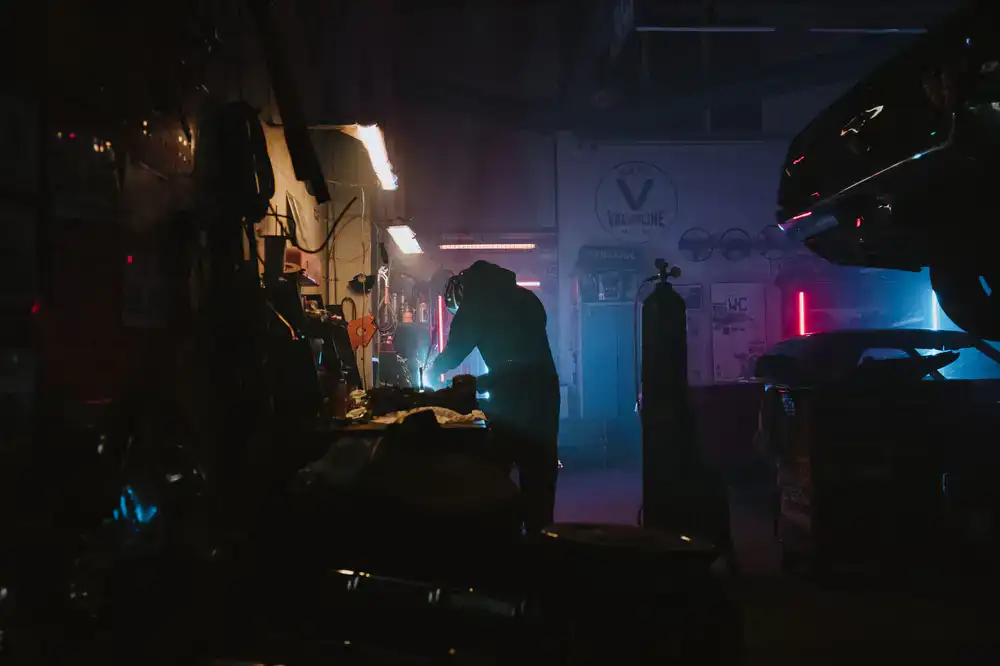 Mechanic crew working on a digital neon race car